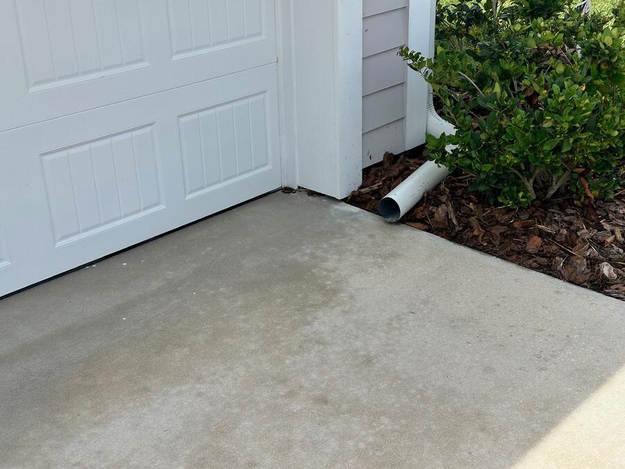 Concrete driveway pressure washing after, evenly cleaned with no wand marks, Windermere FL