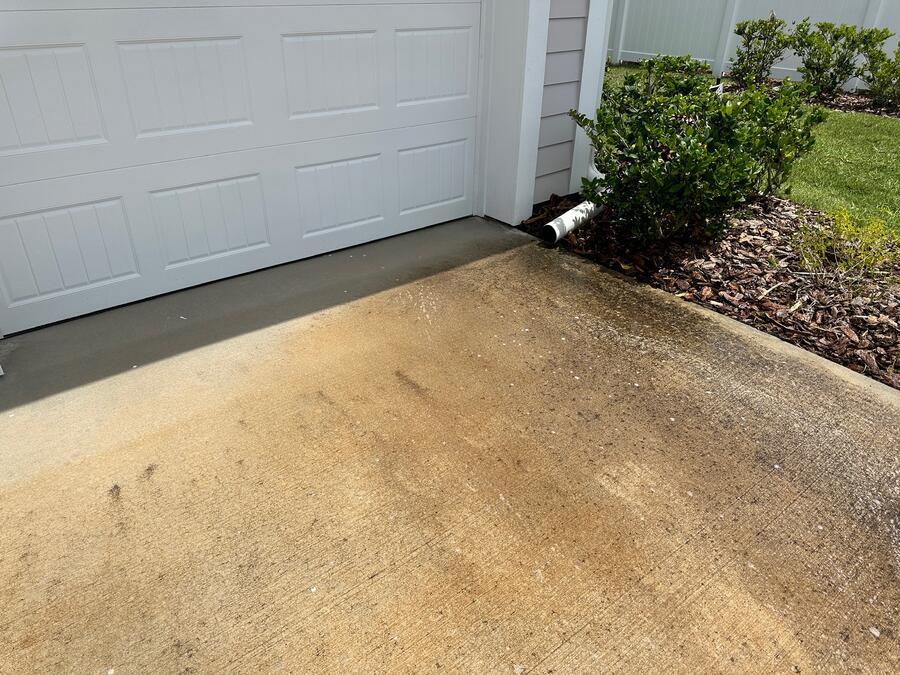 Concrete driveway pressure washing before, greyed by mildew and tannin staining, Windermere FL